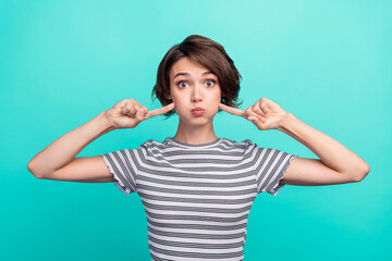 Photo of young girl hold breath fooling point finger cheeks silly isolated over teal color background - obrazy, fototapety, plakaty
