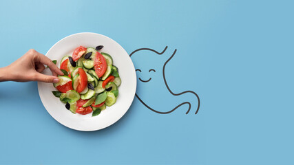 The silhouette of a joyful stomach and a plate with salad on it. A symbol of healthy food for the...