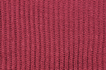 Close up of knitted pattern on burgundy red wool pullover