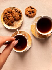 A cup of coffee and sweety cookies