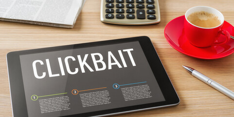 A tablet on a desk with the headline Clickbait