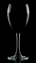 half full wine glass isolated on black background low key rim lighting