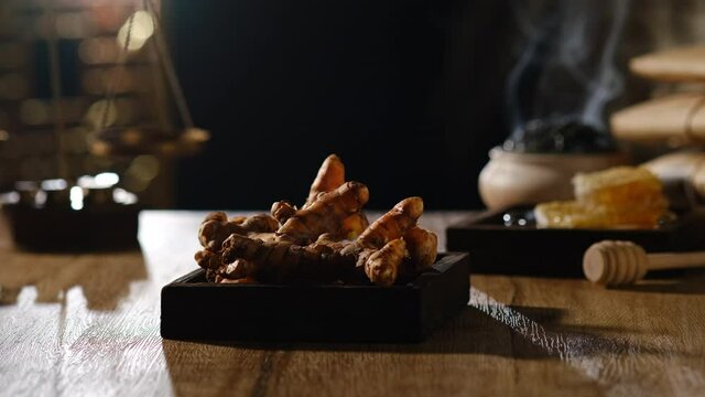 Lighting and smoke with turmeric in a table , for chinese traditional medicine advertising , front view