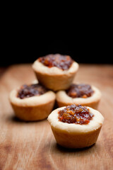 Group of  fruit mince tart on timber bench at Christmas