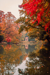 Lake with neoclassical temple "Tempietto del lago dei cigni" in the park of Monza during the autumn foliage