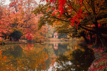 Lake with neoclassical temple "Tempietto del lago dei cigni" in the park of Monza during the autumn foliage