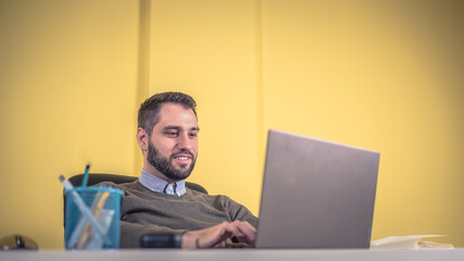 man using notebook and typing at the office