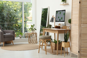 Fototapeta na wymiar Stylish room interior with comfortable workplace. Home office