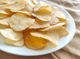 Potato chips or crisps on a white plate.