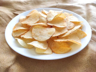 Potato chips or crisps on a white plate.