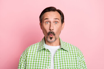 Photo of funky shocked senior man dressed green plaid shirt big eyes isolated light pastel pink color background