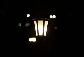 Lantern in the dark. Burning lantern in the dark. Electric lamp.
