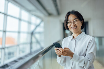Joyful asian businesswoman, posing for the camera