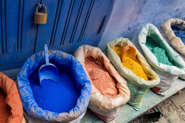 Typical colored pigments to paint the walls of the house in a store, Morocco