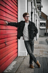 Male punk leaning against shutters