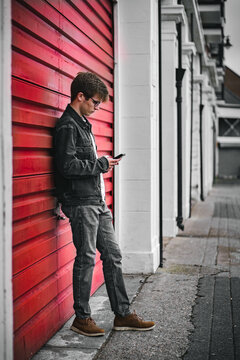 Male punk leaning on shutters