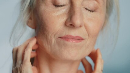 Beautiful Senior Woman Touching Her Neck, Chest, with Sensual Movement of Hands, Enjoying Soft Skin. Elderly Female Natural Beauty. Dignity and Grace in Old Age. Concept for Skin care, Healthy Living