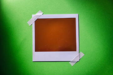 Download Blank photo frame template on green background. Blank square photo frame with tape on wall...