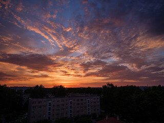 Dramatic red and dark blu clouds over city rooftops