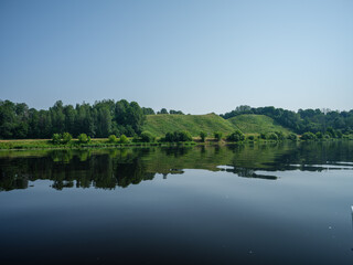 Fototapeta na wymiar country forest lake in summer with deep blue water with reflections