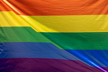 Waving rainbow flag showing support for the LGBT community. Inclusive, pride concept