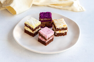 Mini cake desserts in different flavors. Delicious cakes on a white background