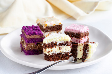 Mini cake desserts in different flavors. Delicious cakes on a white background. Close up