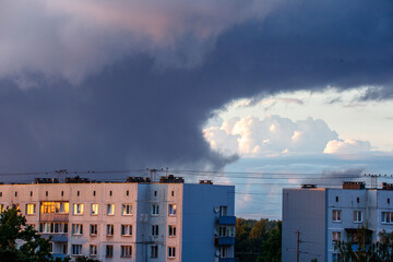 Dramatic red and dark blu clouds over city rooftops