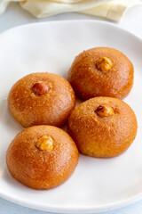 Delicious turkish sweet sekerpare on served. Traditional Turkish dessert sekerpare or badempare on a white background. Story format