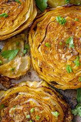 Roasted cabbage steak, baked cabbage in the oven with spices close-up. Vegan cuisine, white cabbage recipe. Homemade authentic dish, baked vegetables background. Healthy food concept, vegetable side 