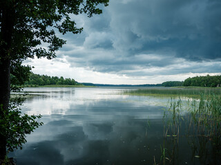 dramatic clouds over blue lake