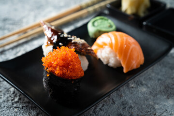 Selection of sushi on rustic background, copy space