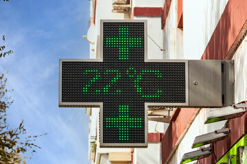 Electronic green pharmacy cross with the temperature indication in celsius degrees