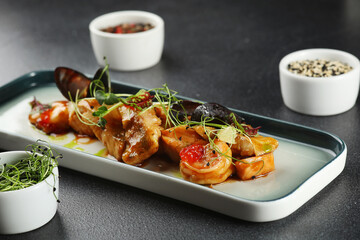 seafood plate with mussels and shrimp toped microgreen closeup