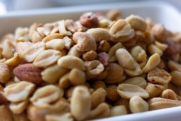 Close up of a bowl of salty peanuts. Nuts, healthy snack concept