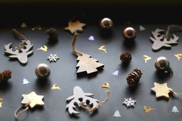 Various Christmas ornaments and colorful sequins on dark background. Selective focus.