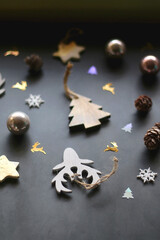 Various Christmas ornaments and colorful sequins on dark background. Selective focus.