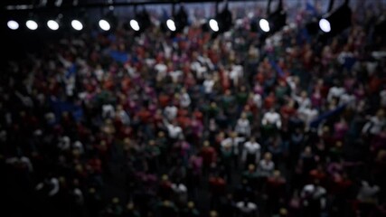 Crowd of defocused People Cheering, clapping, Applauding, Having Fun, Celebrating at Sport Event, Concert, TV show, Festival, Background Silhouette. High quality 4k footage