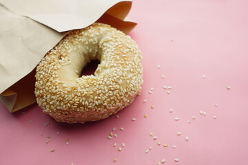 fresh bagel bread in a paper on table 