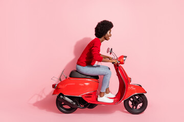 Fototapeta na wymiar Profile side view of nice attractive cheerful wavy-haired girl riding moped isolated over pink pastel color background