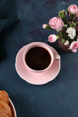 Black coffee with cinnamon and croissant