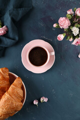 Black coffee with cinnamon and croissant