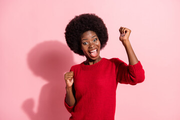 Portrait of attractive cheerful girl rejoicing great luck having fun dancing isolated over pink pastel color background