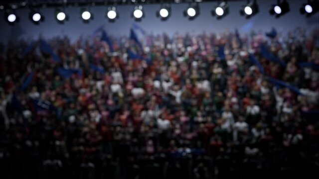 Crowd of defocused People Cheering, clapping, Applauding, Having Fun, Celebrating at Sport Event, Concert, TV show, Festival, Background Silhouette. High quality 4k footage