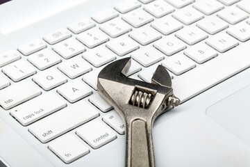 An Adjustable Wrench on a Laptop Keyboard