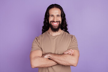 Photo of young cheerful guy crossed hands glad confident casual outfit isolated on violet color background
