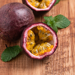 Delicious juicy passion fruit on wooden table background.