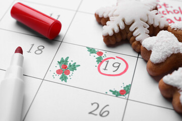 Saint Nicholas Day. Calendar with marked date December 19, marker and snowflake shape gingerbread cookies, closeup