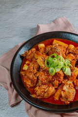 Korean food Spicy Stir-fried Chicken tteokbokki dish on black plate