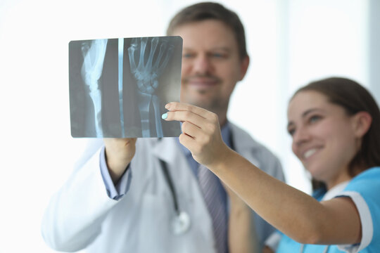 Doctors looking at xray of hand in clinic closeup